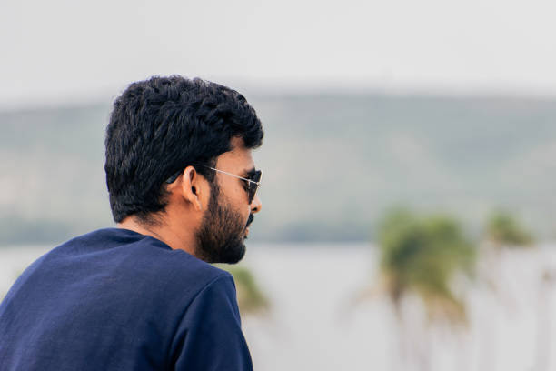 istock Young attractive man with beard looking at beach. 1455397039
