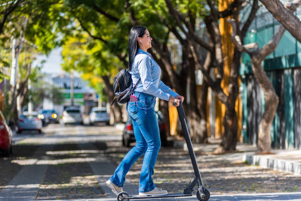 istock Young woman using electric skateboard in the city 1455400815