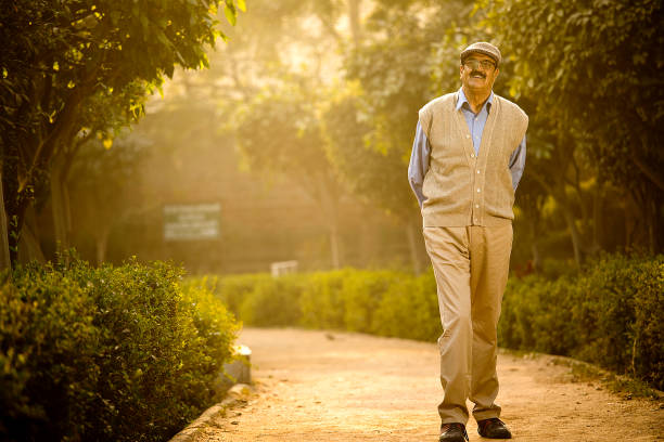 Smiling senior man with walking at park