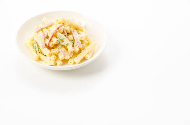 Macaroni salad with mayonnaise, cucumber, corn and ham.