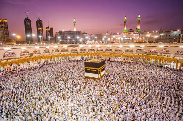 Photo of Muslim pilgrims from all around the world doing tawaf, praying around the kabah in Mecca, Saudi Arabia