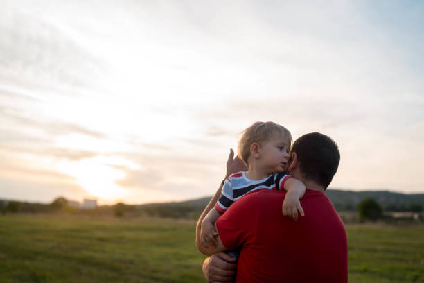 istock Cheerful dad take his laughing son in his arms outside 1455410099