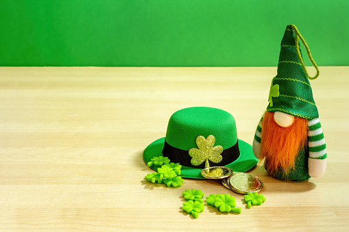 Bearded scandi gnome with green hat and clover leaves. St Patrick´s day.