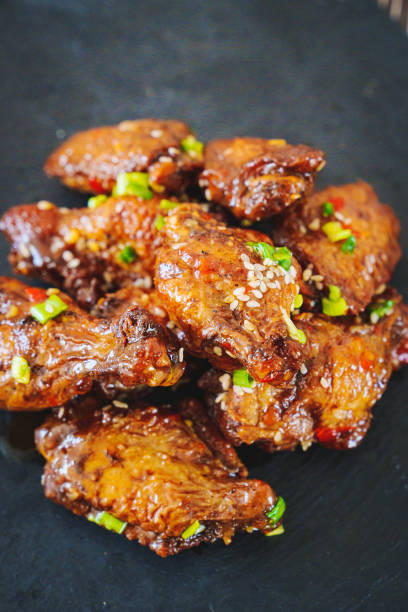 istock fried chicken with garlic and sesame in caramel on a black tray. 1455415561
