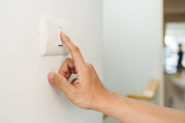 istock Closeup of finger is turning off on lighting switch 1455417273