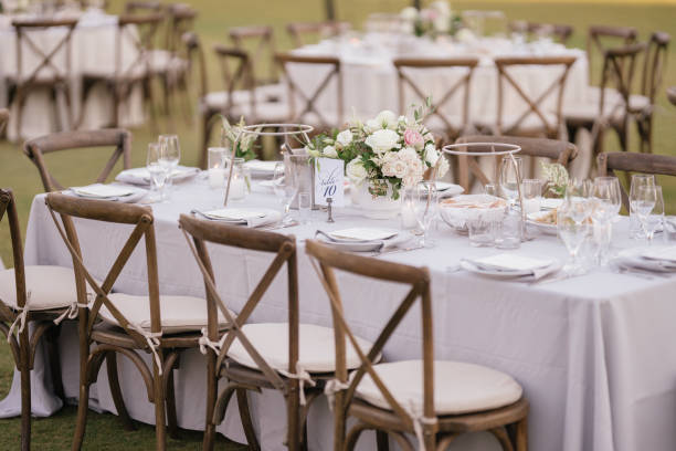 istock outdoor event, white chairs and tables placed outside 1455418219