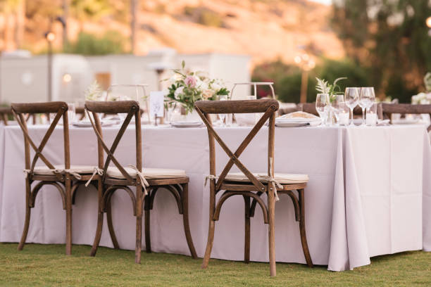 istock outdoor event, white chairs and tables placed outside 1455418301