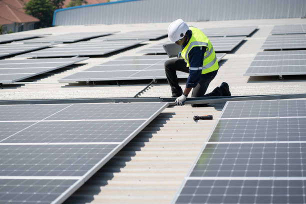 istock African American engineer man use electric screwdriver and computer notebook working with solar panel on roof factory 1455418668