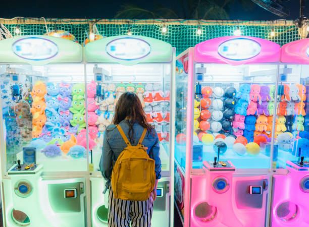 Young Caucasian woman playing on claw machine