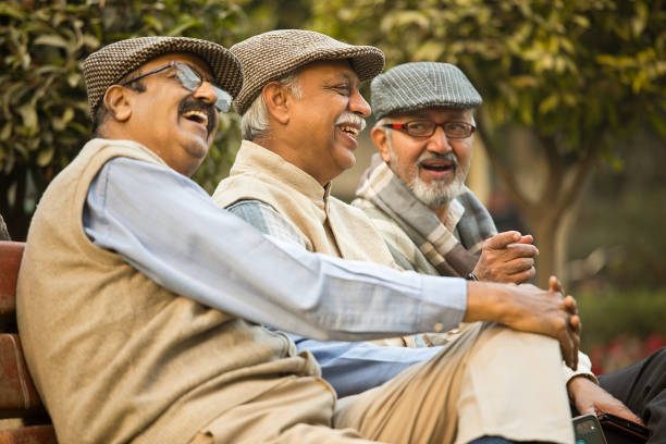 istock Senior male friends having fun at park 1455422719