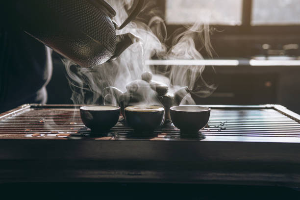 istock Warm a cup of tea,Process brewing tea.Hot water is poured from the kettle into a kettle 1455422726