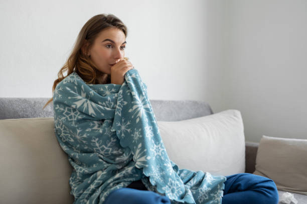 istock Woman freezing at home 1455422833
