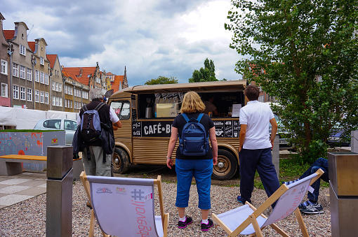 Gdansk, Poland – September 22, 2015: GDANSK, People standing in front of a coffee bus in the city center