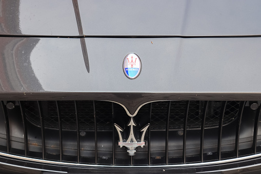 Kiel, Germany – May 15, 2021: Closeup of the Maserati logo on a new car front
