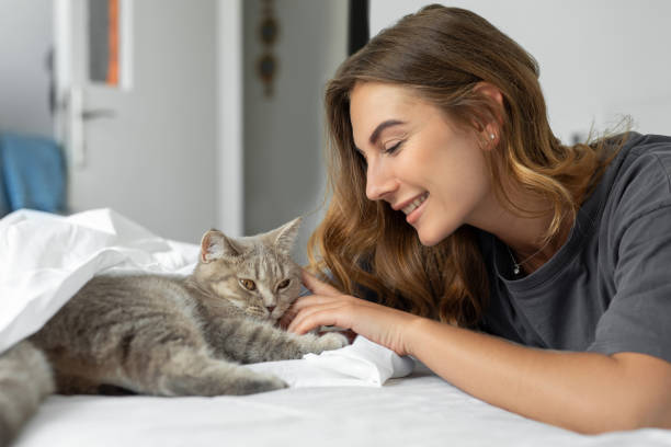 istock Woman with cute cat resting at home 1455432846