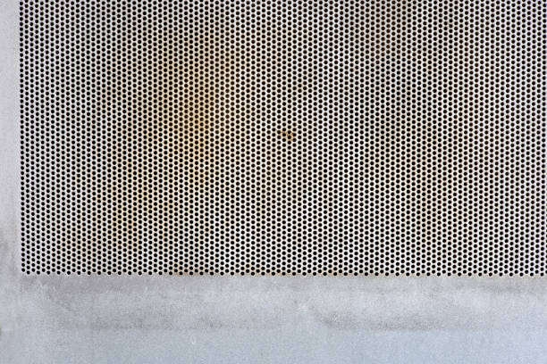 old dirty white metal background with perforated surface