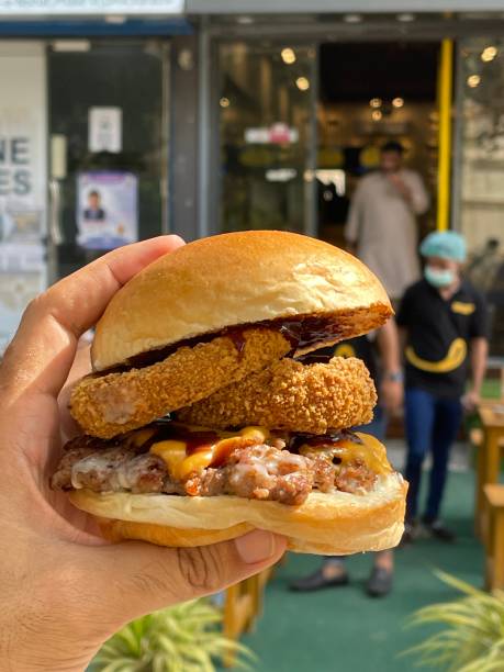 Person holding a delicious chicken burger