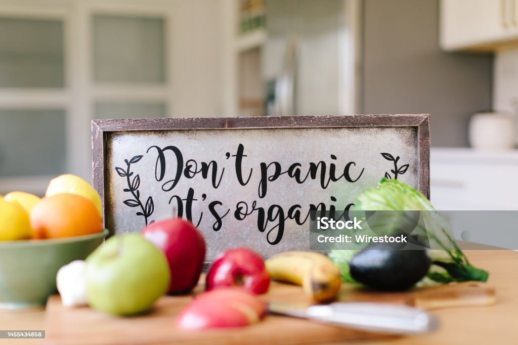 Closeup shot of vegetables and a sign "don't panic it's organic" - healthy lifestyle concept A closeup shot of vegetables and a sign "don't panic it's organic" - healthy lifestyle concept Apple - Fruit Stock Photo