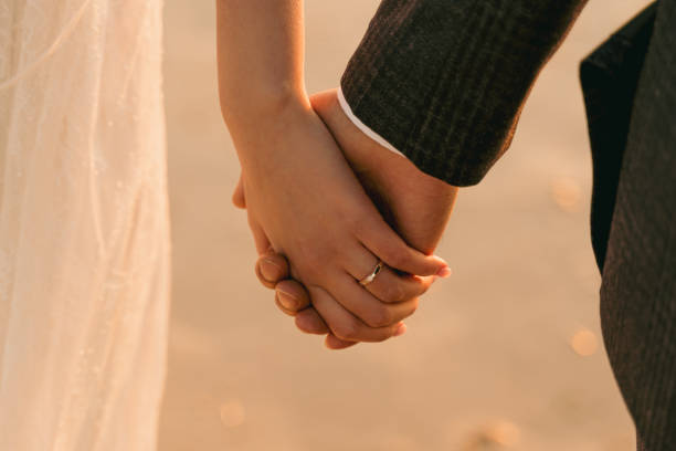 istock Bride and groom holding hands together 1455435053