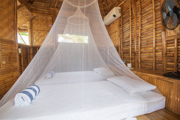 istock Hotel room in a rustic style with two canop beds 1455436428