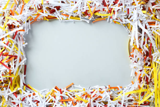 istock Frame of shredded colorful paper strips on white background, flat lay. Space for text 1455437498