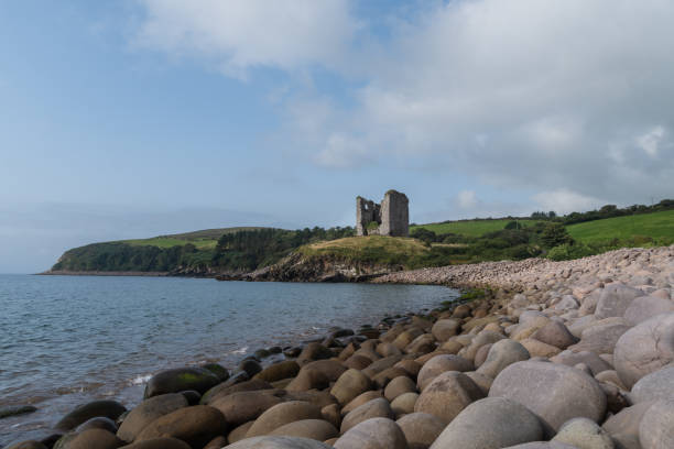 istock Cloudy sky over the Minard Castle in Ireland 1455438692
