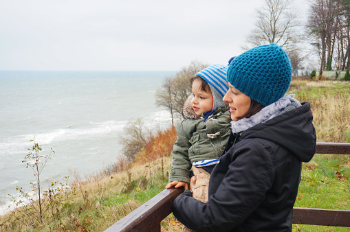 The Mother and son watching the sea on a cloudy day