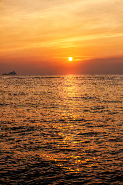 istock Beautiful sunset landscape with dramatic sky, sun and sea water 1455440060