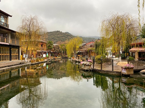 December 18, 2022—Lijiang, Yunan, China: Lijiang Ancient City (Dayan Old Town) on the Yungui Plateau has a history of more than 700 years. It is a well-preserved Naxi ancient town, listed as UNESCO World Heritage site in 1997. It is one of the four best-preserved ancient cities in China. In the vicinity area of Lijiang, there are also many other beautiful ancient towns. Here is the street view of Shuhe Ancient Town.