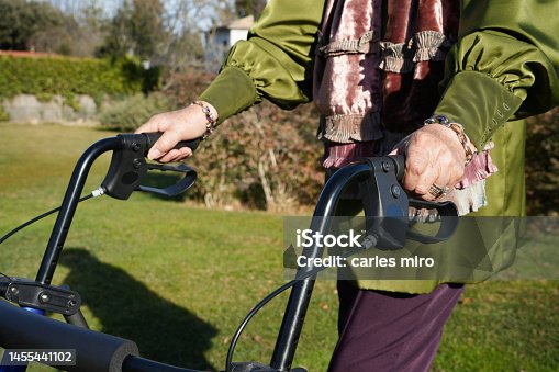 istock Closeup of senior grandmother hands holding a walker 1455441102