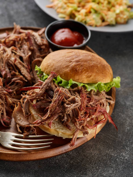 istock Pulled pork burger. Burger with pork meat on a wooden board 1455441120