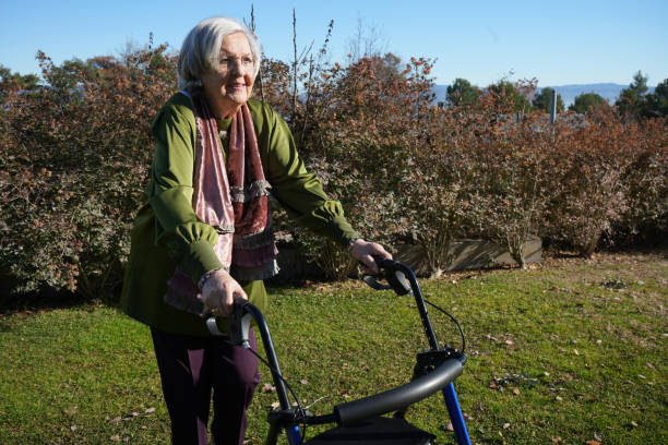 istock Senior elderly woman with a walker in a garden 1455441132