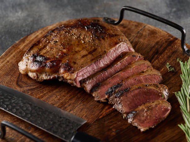 istock Grilled beef heart steak with pepper on a wooden board. 1455441584