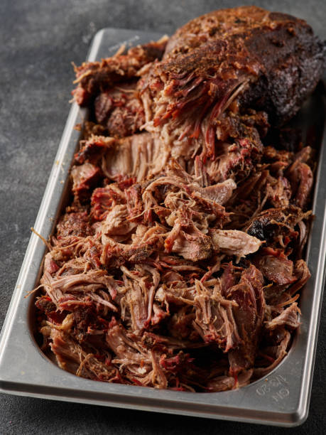 istock Traditional barbecue pulled pork. Slow cooked pulled pork shoulder. Juicy pork meat cooked in a smoker by low and slow 1455441611