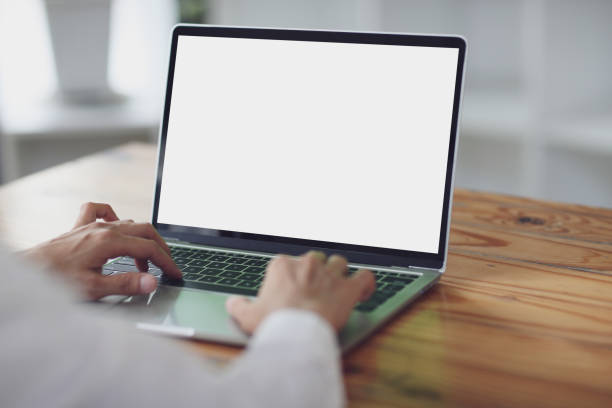 istock woman using and typing on laptop computer with blank white desktop screen on wooden table 1455443310