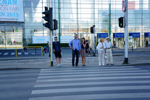 Poznan, Poland – August 25, 2013: The People waiting at a zebra crossing for green light