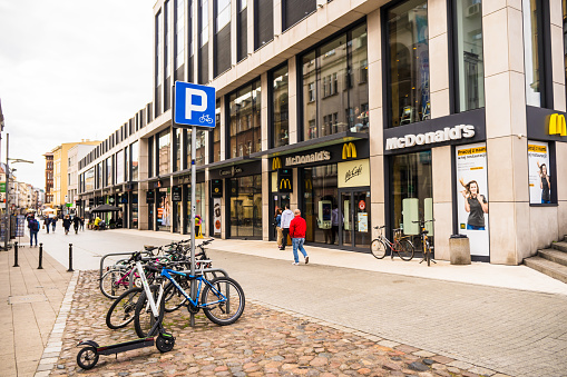 Poznan, Poland – September 19, 2021: Locked bicycles close-by McDonald's restaurant in the city center, Poznan, Poland