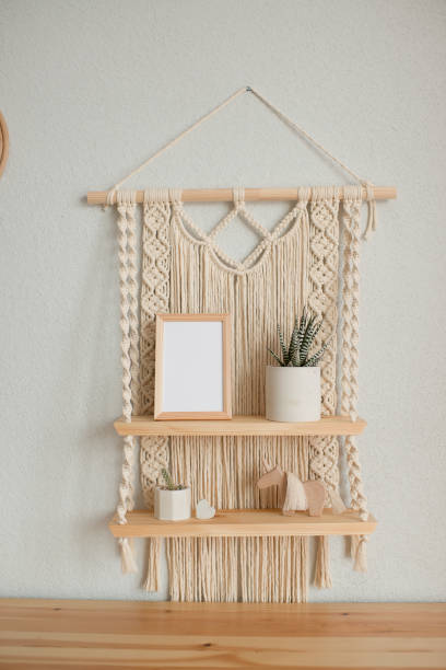 istock Mockup wooden frame on decorative shelves macrame in the interior 1455444089