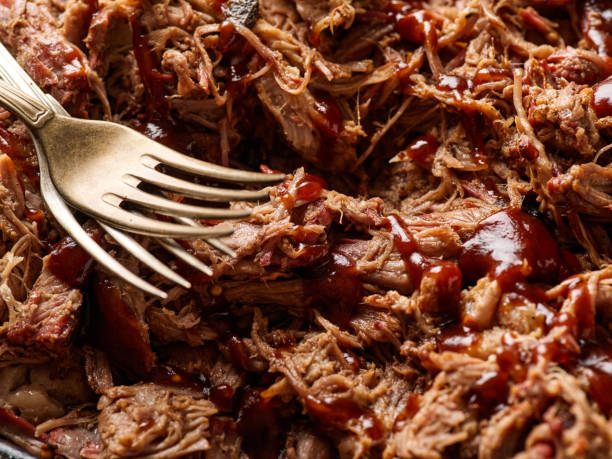 istock Traditional barbecue pulled pork. Slow cooked pulled pork shoulder. Juicy pork meat cooked in a smoker by low and slow 1455446401