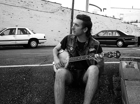 kansas cit, United States – October 04, 2013: A grayscale shot of a street musician playing and singing in Kansas City, United States