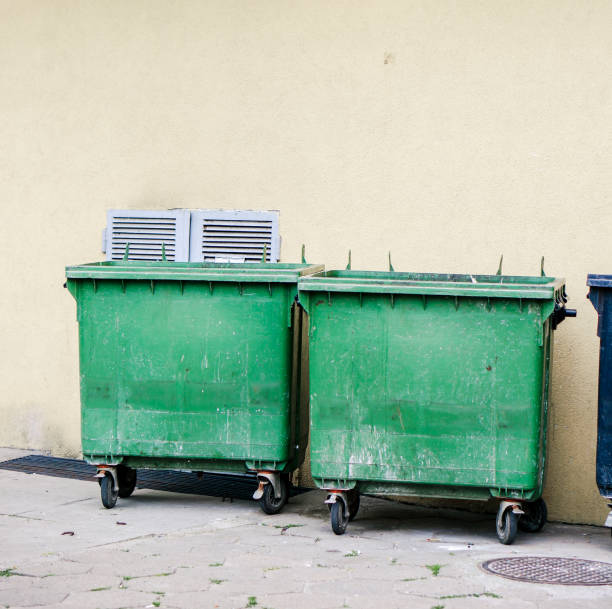 istock Green dirty plastic trash bins in the street 1455446680