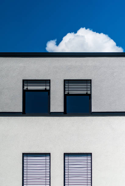 istock Vertical shot of a modern gray building with windows on a sunny day 1455448436