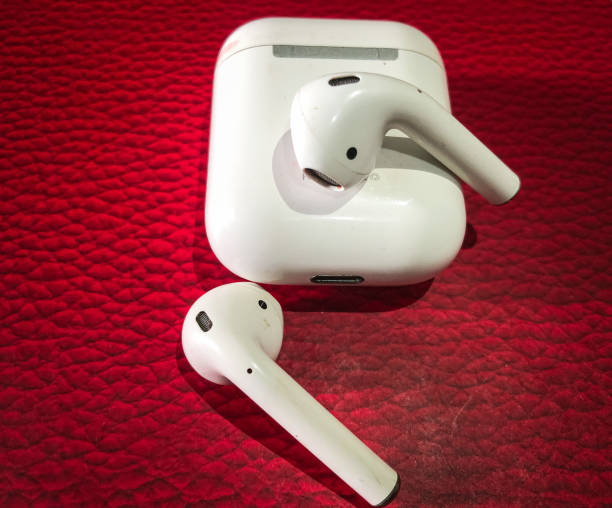 istock Close-up Wireless Earphone isolated on red background 1455449739