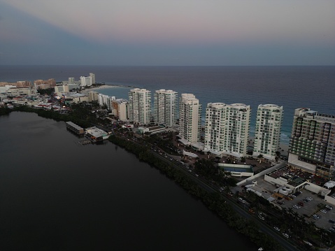 An aerial view of cityscape Miami surrounded by buildings and water during sunset