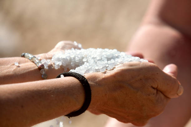 Dead Sea salt crystals in woman hands, natural minerals for health