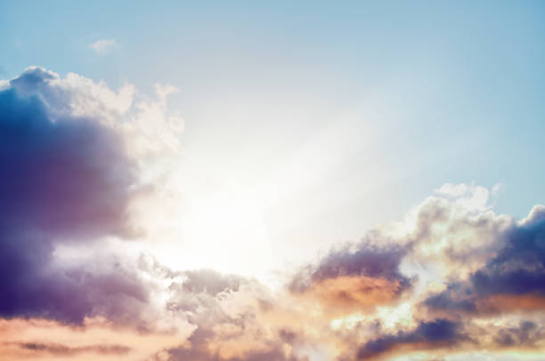 istock cloudy sky with sun rays breaking through fluffy clouds. as a symbol of a new beginning and a new path 1455457194