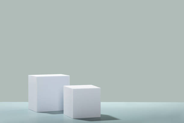 istock Abstract empty white podiums cubes with eucalyptus leaves on blue background 1455457283