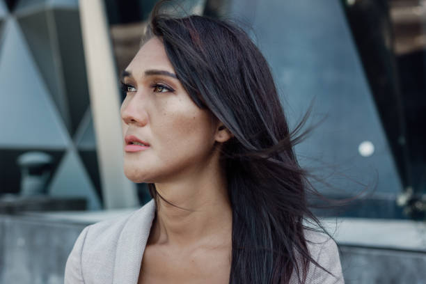 istock Asian transgender person portrait with cold look facing sideways 1455457656