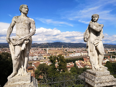 The famous Florence cityscape beneath old statues at Bardini garden, Tuscany.