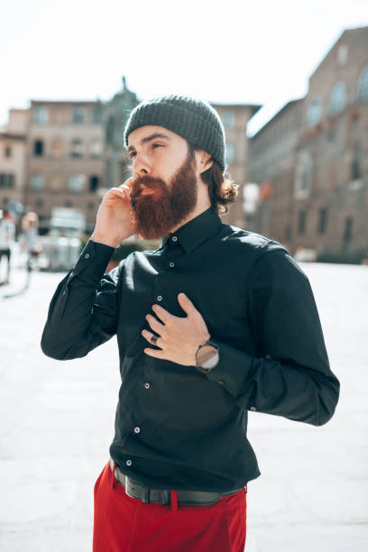 istock hipster man using the phone in the city 1455457936